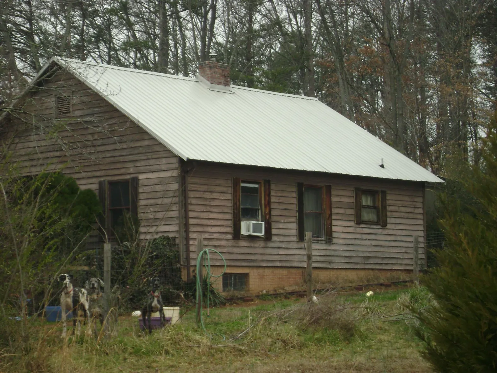 White metal roof on an old wood sided farmhouse, from a Metal Roof Installation job in South Bay